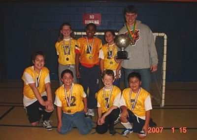 soccer team with medals and trophy